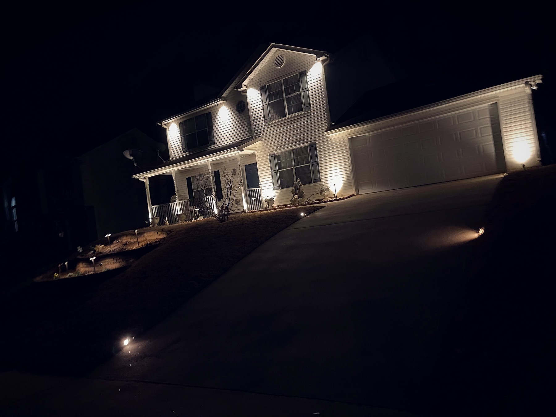 Lighting Homes on Sloped & Uphill Lots: Why We Design On-Site at Dusk